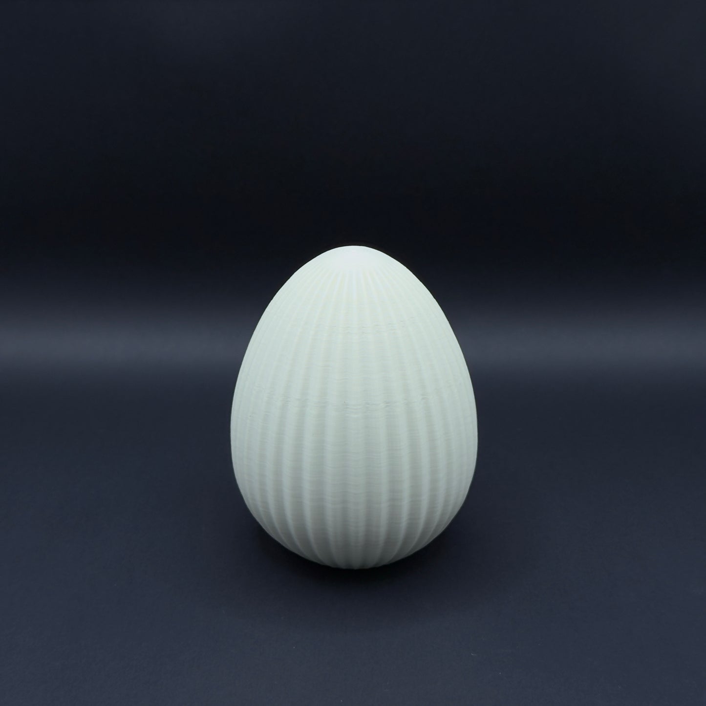 Large Nordic egg in bone white by MX³ Design, showcasing a smooth, minimalist surface and elegant shape.