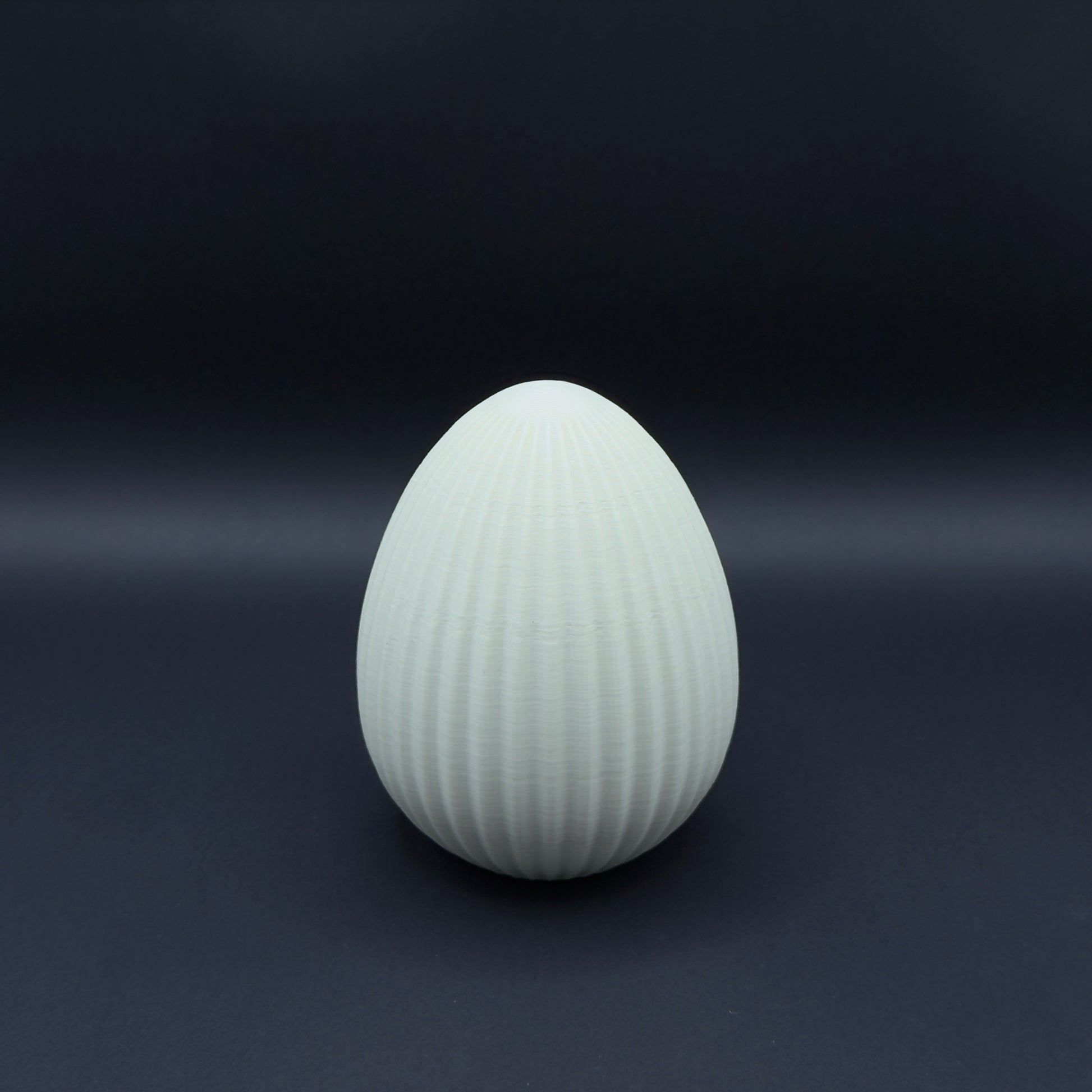Large Nordic egg in bone white by MX³ Design, showcasing a smooth, minimalist surface and elegant shape.