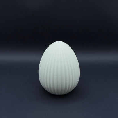 Large Nordic egg in bone white by MX³ Design, showcasing a smooth, minimalist surface and elegant shape.