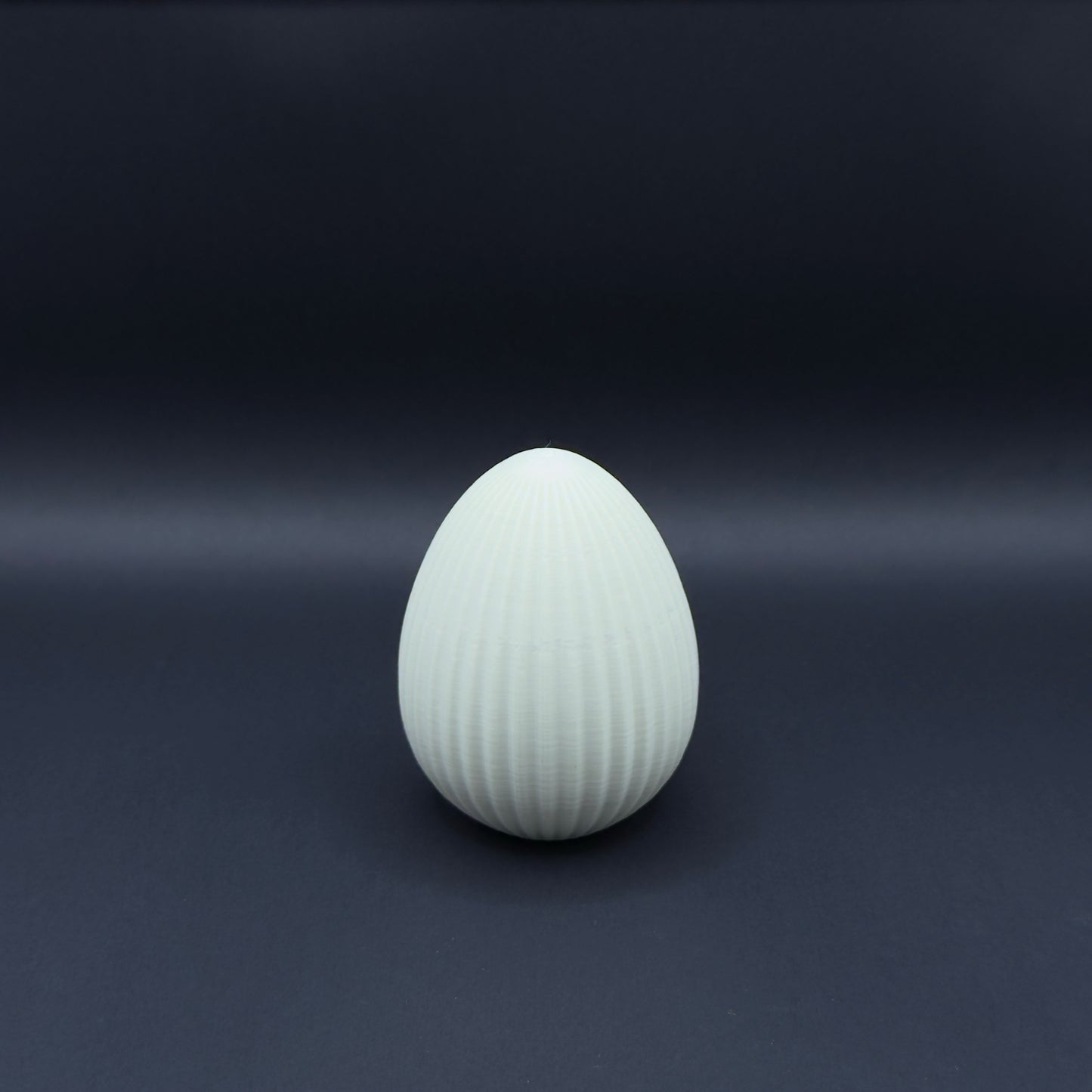 Osterei Nordic in bone white, medium size, designed by MX³ Design, showcasing its smooth, elegant surface.